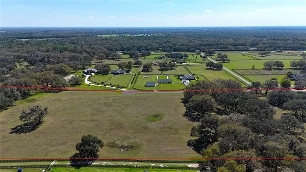 an aerial view of a golf course with parking space