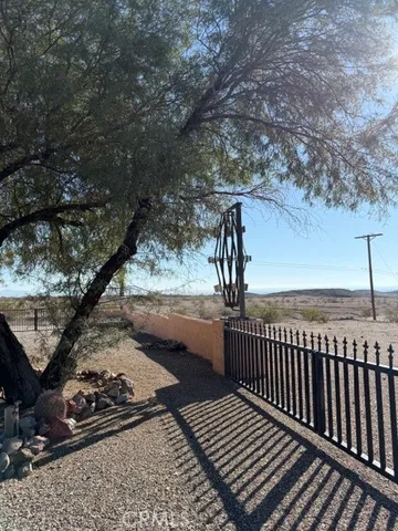 a view of a hallway with wooden floor and closet