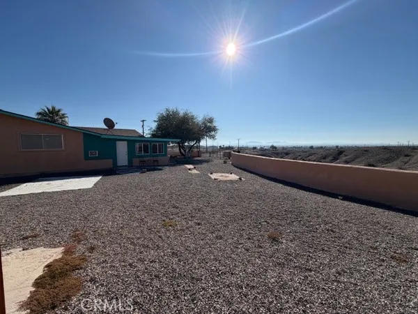 a living room with furniture fireplace and large windows