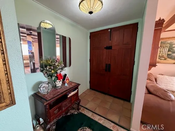 a living room with furniture a window and a flat screen tv