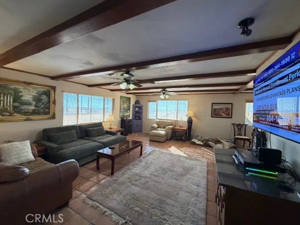 a living room with furniture fireplace and a large window