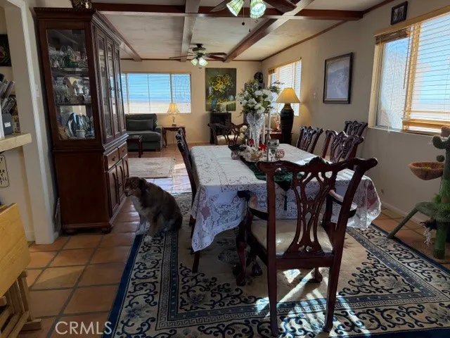 a living room with furniture a window and a flat screen tv