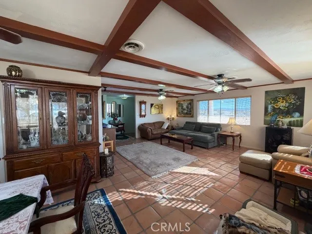 a living room with furniture fireplace and a large window