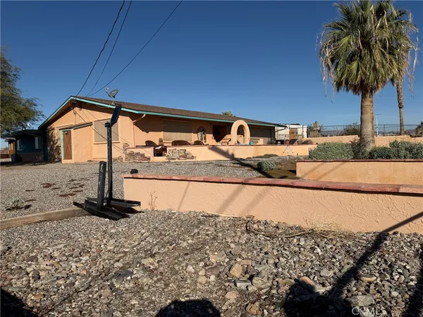 a view of a chairs and table in the balcony