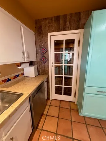 a view of water heater room with wooden floor and rug