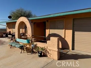 a view of a dry yard with wooden fence