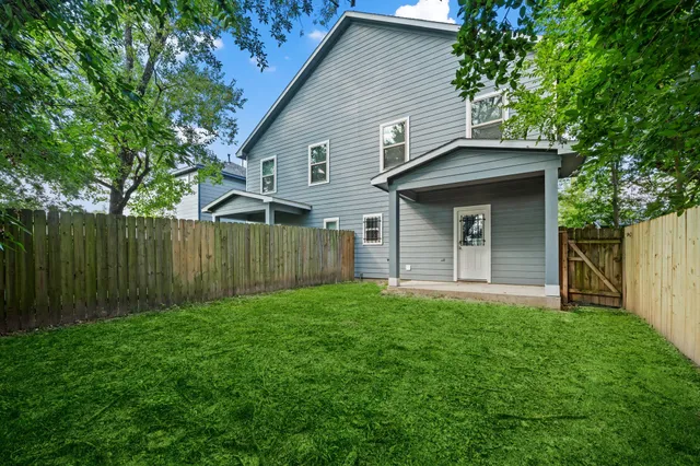 a front view of a house with yard and green space
