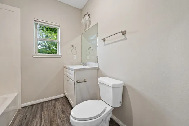 a white toilet sitting next to a bathroom sink