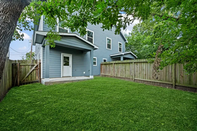 a front view of a house with yard and green space