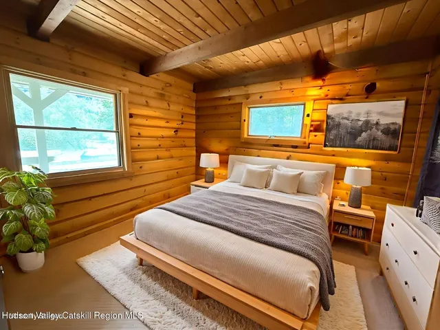 a view of a balcony with chairs and wooden floor