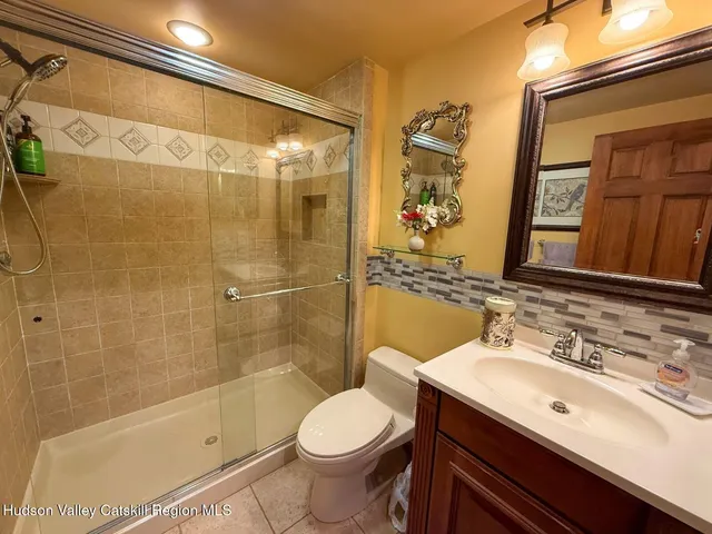 a view of a house with a yard covered in snow