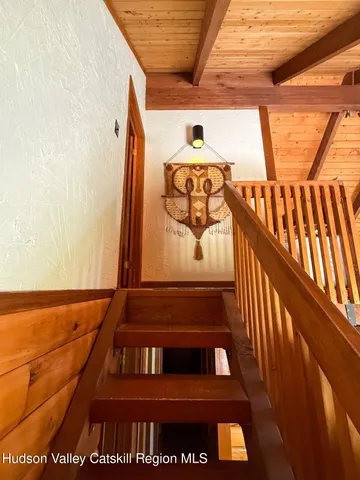 a front view of a house with a yard covered in snow