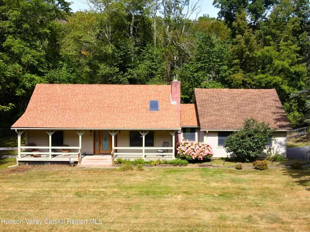 a backyard of a house with table and chairs