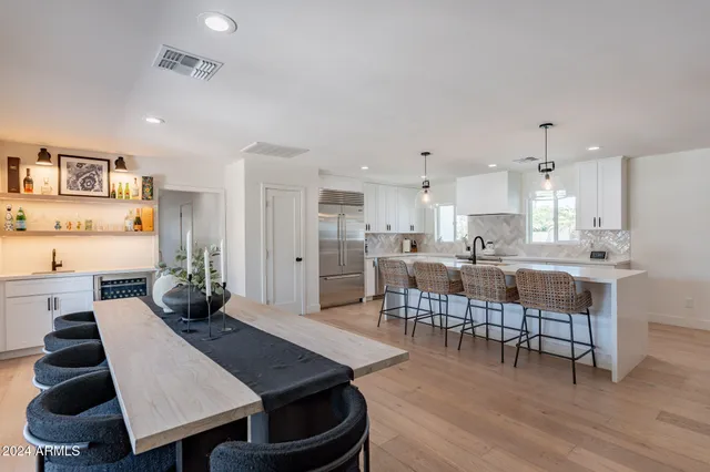 a living room with furniture and kitchen view