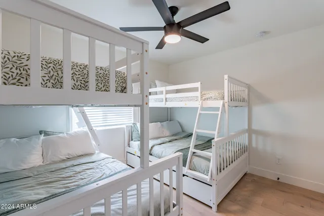 a bedroom with a large bed and a chandelier