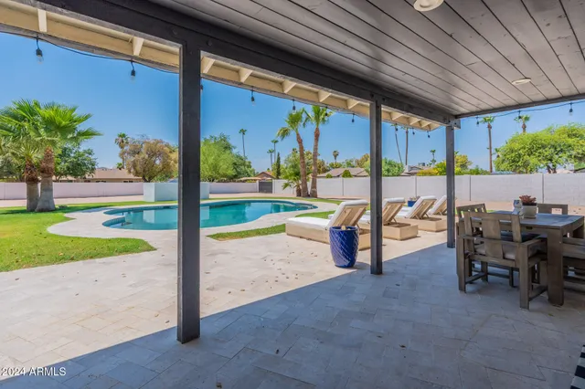 a view of a patio with a table and chairs