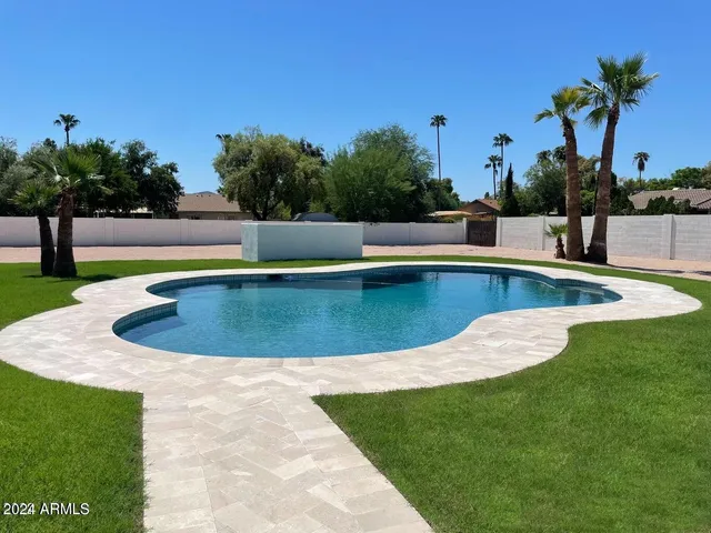 a view of a swimming pool with a yard