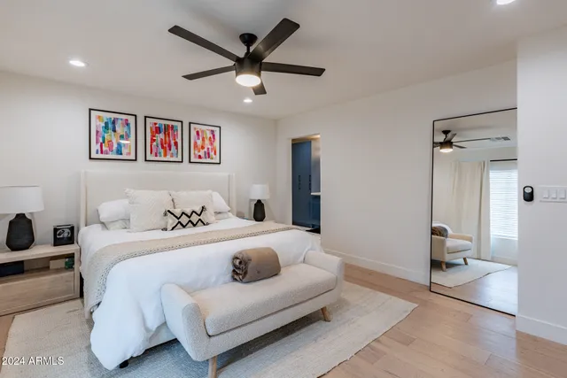 a bedroom with a large bed and a chandelier