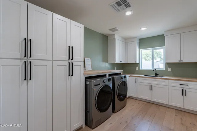 a utility room with sink dryer and washer