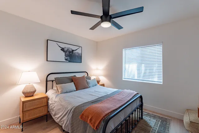 a bedroom with a bed and a window