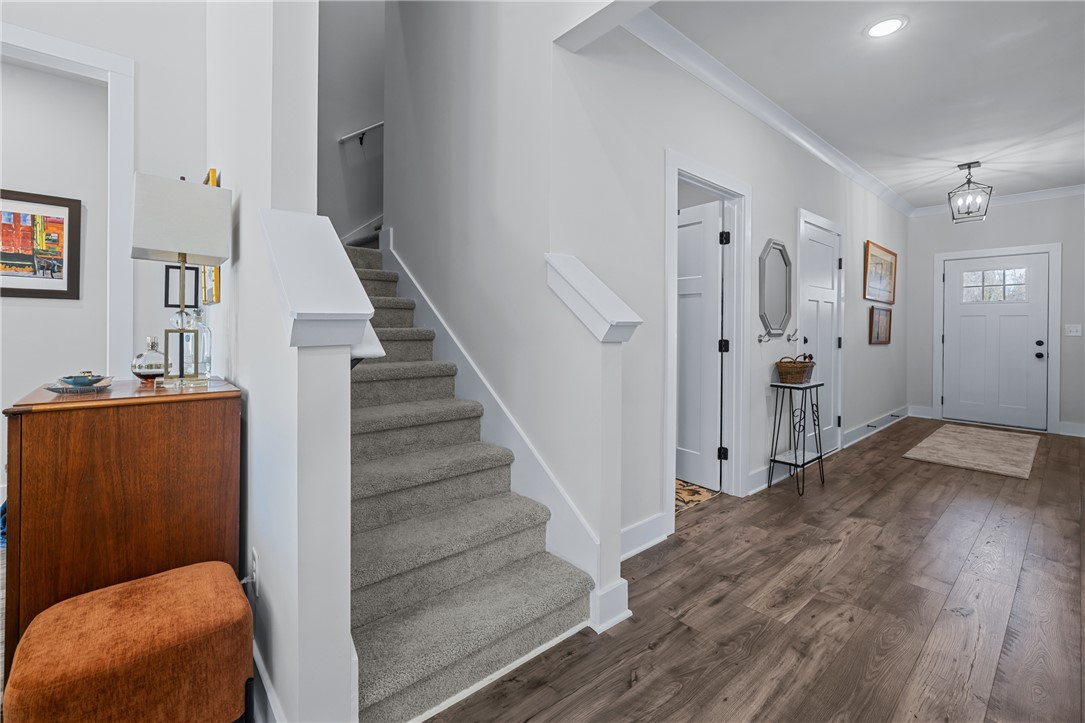 135 Bowers Estates Road Hartwell, GA 30643 - Photo 26 of 35 This inviting entry features durable flooring, a staircase, and ample natural light, creating a welcoming atmosphere.