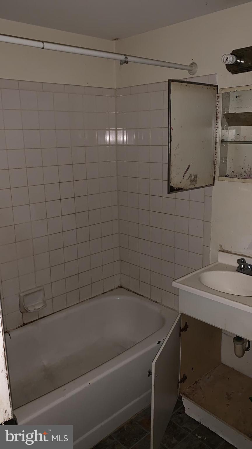 2634 Bowen Road Southeast, Unit 202 Washington, DC 20020 - Photo 6 of 11 a bathroom with a sink and mirror