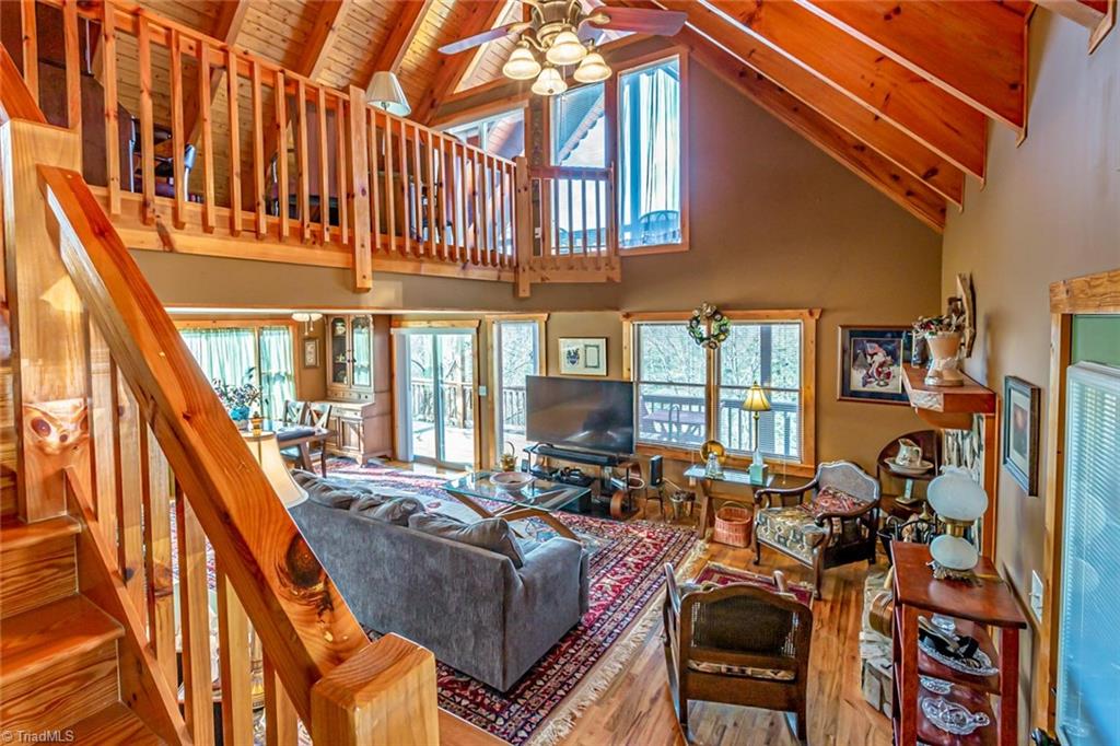 83 Mountain Ridge Road Piney Creek, NC 28663 - Photo 4 of 39 View of living and dining area from steps going up to loft