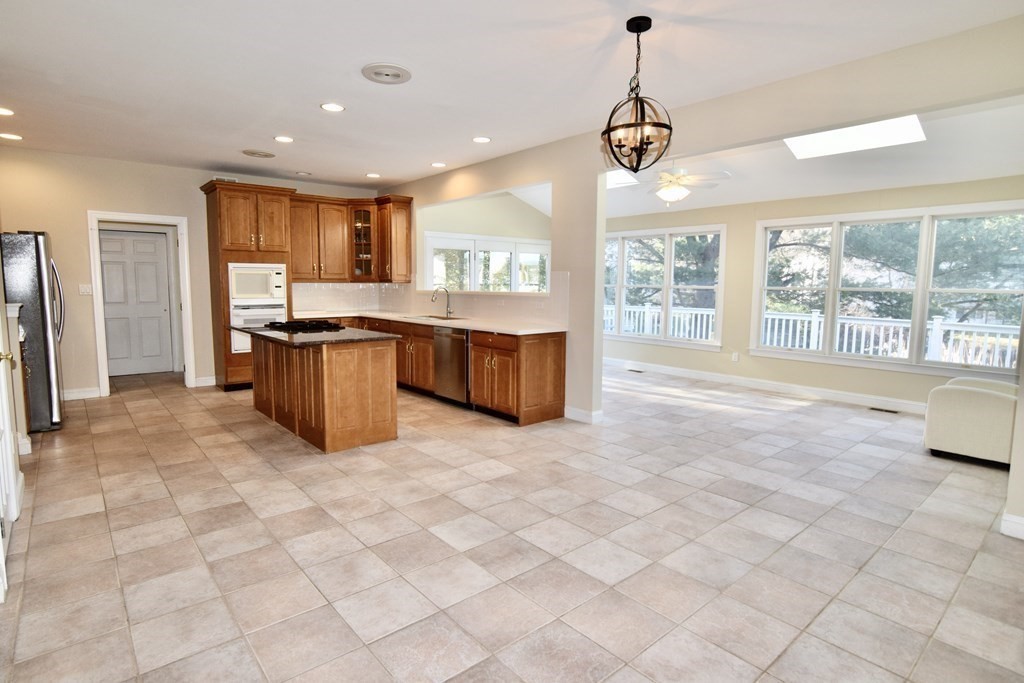 43 Cherokee Road Canton, MA 02021 - Photo 7 of 22 a large kitchen with kitchen island granite countertop a large window and a counter space