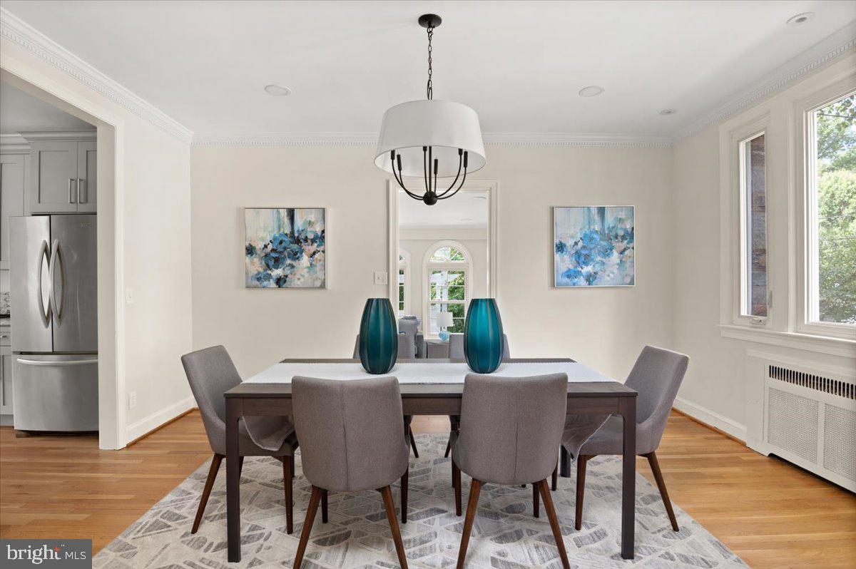 9214 Crosby Road Silver Spring, MD 20910 - Photo 15 of 65 a dining room with furniture a rug a potted plant and a chandelier