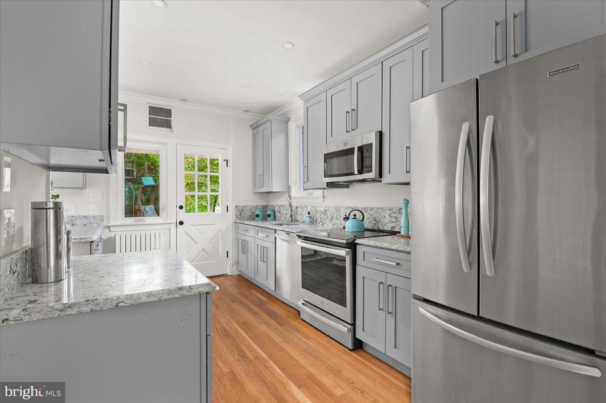 9214 Crosby Road Silver Spring, MD 20910 - Photo 22 of 65 a kitchen with granite countertop a refrigerator stove and sink