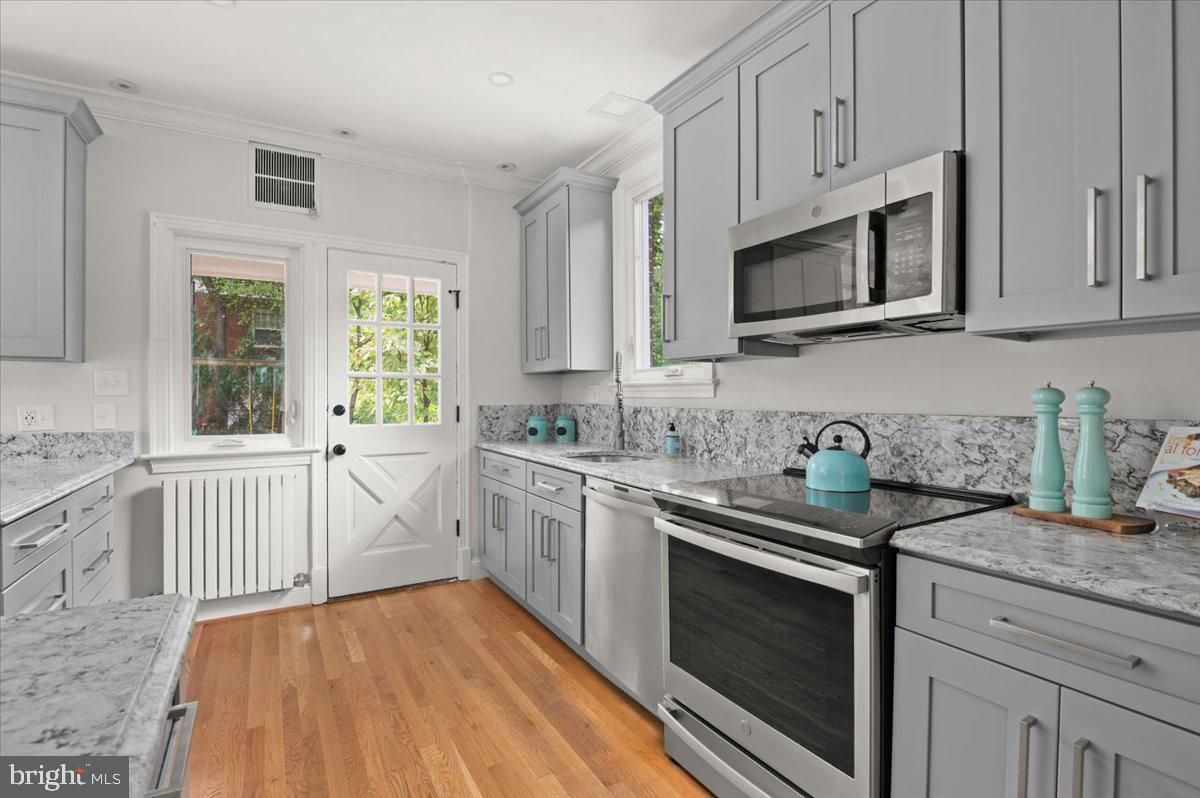 9214 Crosby Road Silver Spring, MD 20910 - Photo 23 of 65 a kitchen with stainless steel appliances a stove microwave and sink