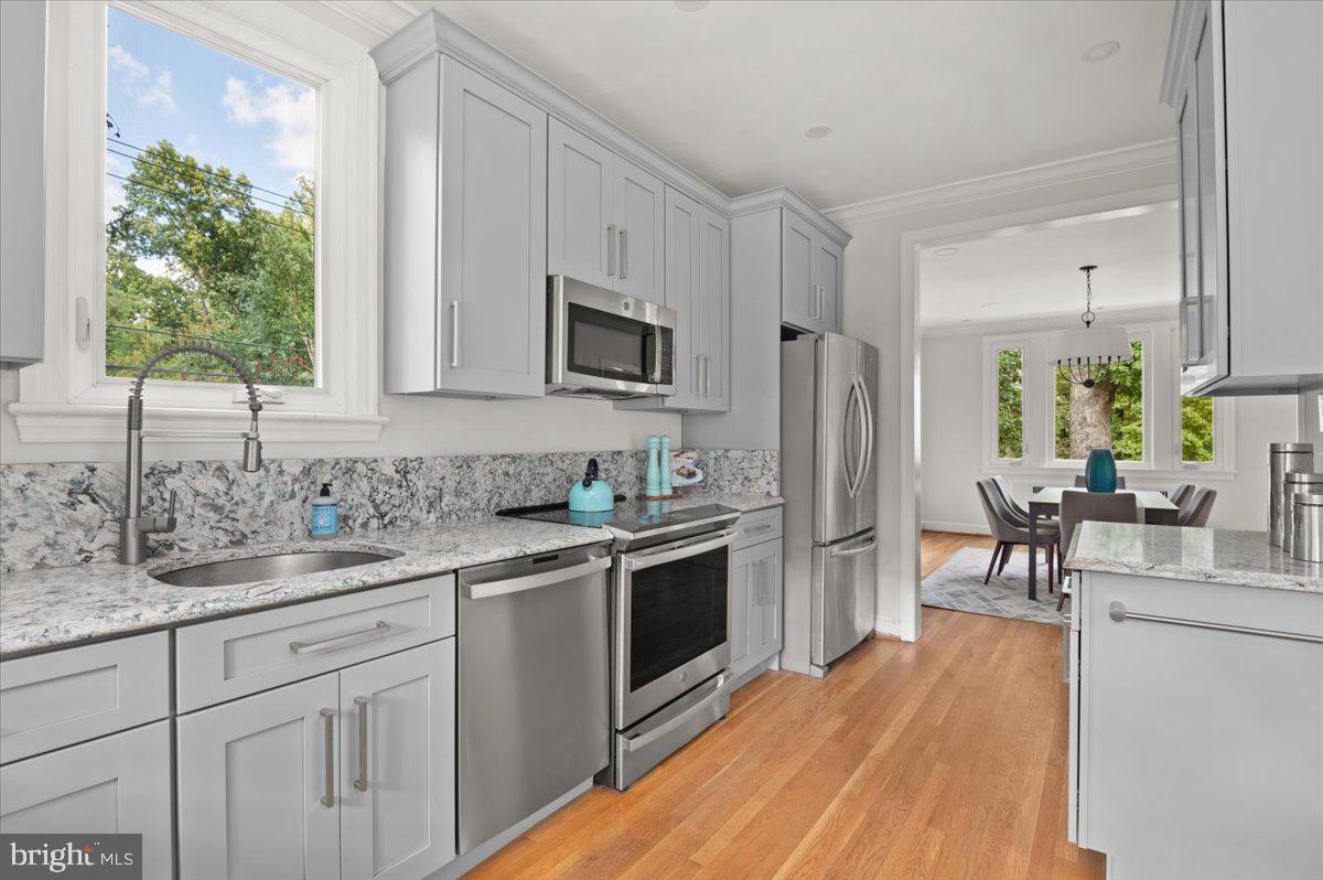 9214 Crosby Road Silver Spring, MD 20910 - Photo 24 of 65 a kitchen with a sink stove and microwave