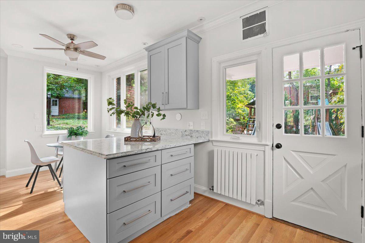 9214 Crosby Road Silver Spring, MD 20910 - Photo 26 of 65 a kitchen with stainless steel appliances sink cabinets and wooden floor