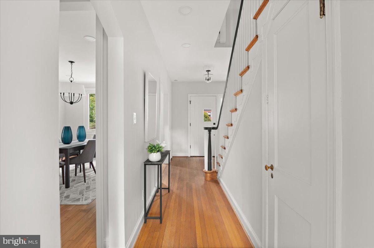 9214 Crosby Road Silver Spring, MD 20910 - Photo 29 of 65 a view of a hallway with wooden floor and staircase