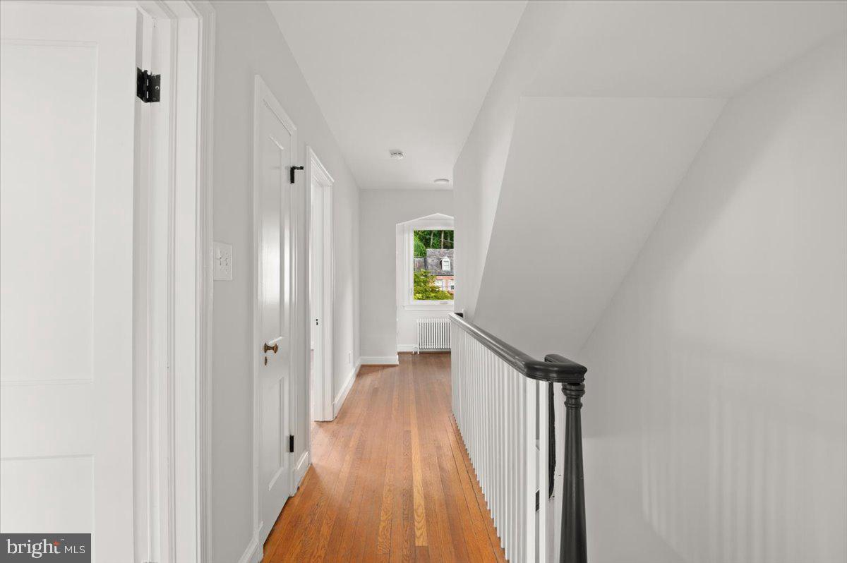 9214 Crosby Road Silver Spring, MD 20910 - Photo 30 of 65 a view of a hallway with wooden floor and staircase