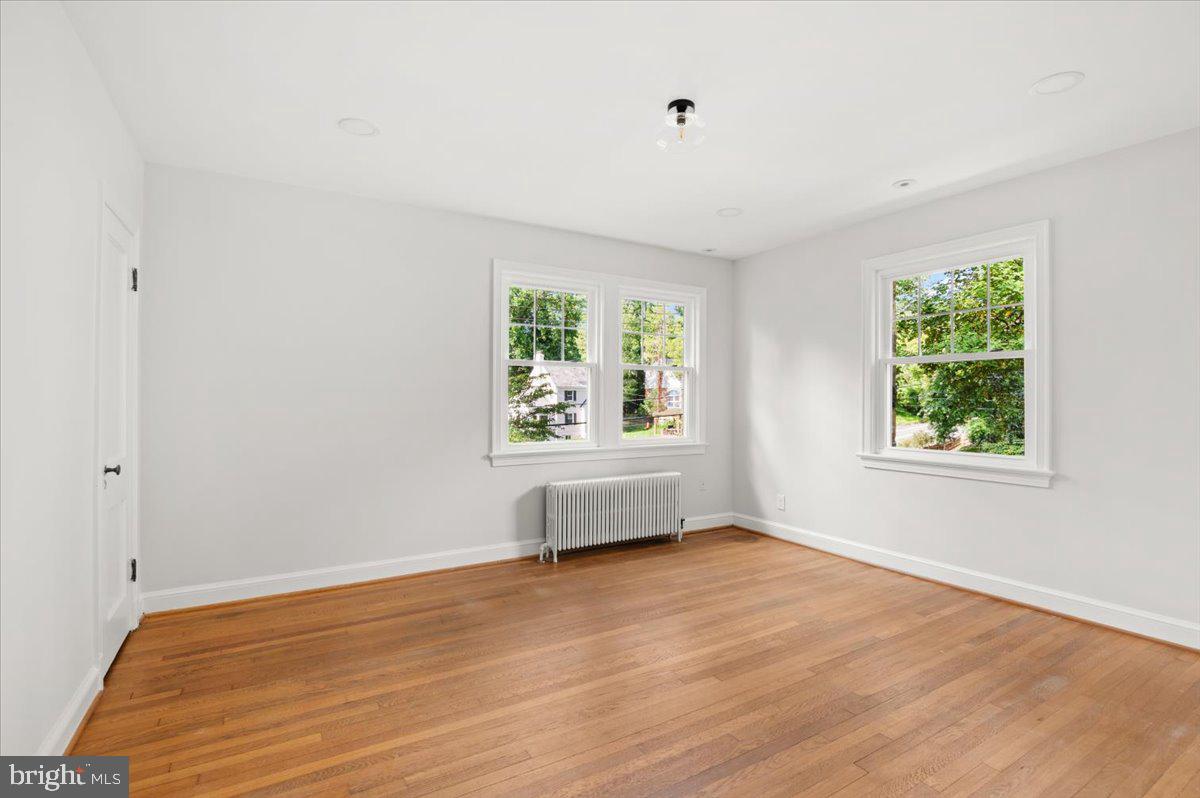 9214 Crosby Road Silver Spring, MD 20910 - Photo 35 of 65 an empty room with wooden floor and windows