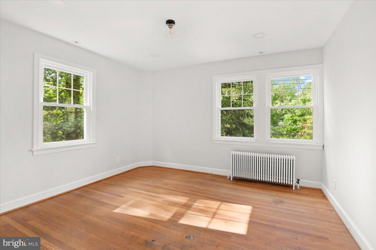 9214 Crosby Road Silver Spring, MD 20910 - Photo 36 of 65 an empty room with wooden floor and windows