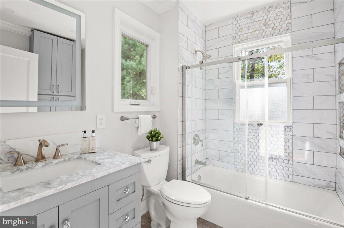 9214 Crosby Road Silver Spring, MD 20910 - Photo 37 of 65 a bathroom with a granite countertop sink toilet and shower