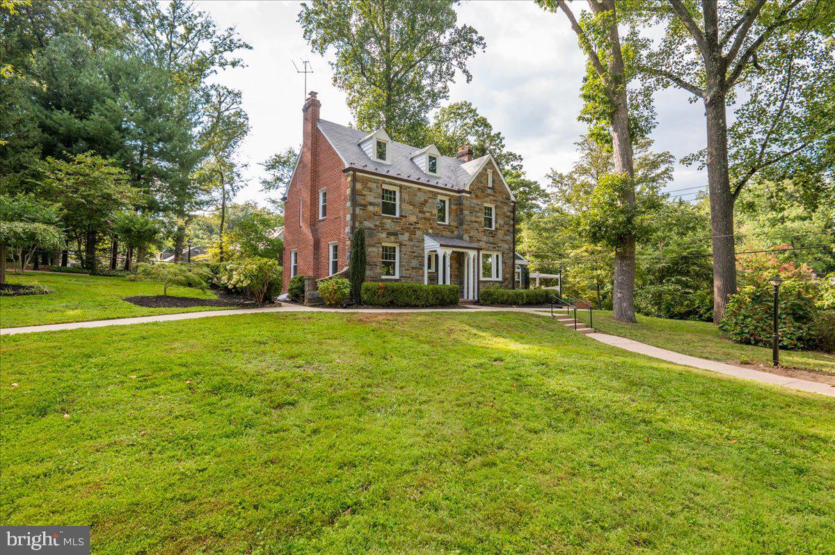 9214 Crosby Road Silver Spring, MD 20910 - Photo 4 of 65 a view of a house with a big yard and large trees