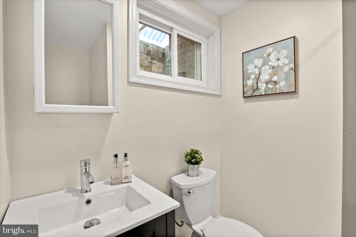 9214 Crosby Road Silver Spring, MD 20910 - Photo 48 of 65 a bathroom with a toilet a sink and a mirror
