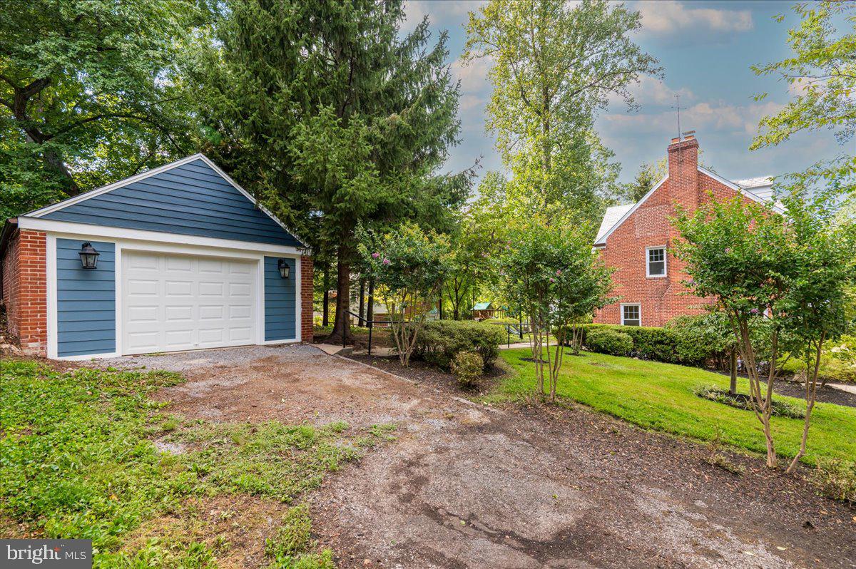 9214 Crosby Road Silver Spring, MD 20910 - Photo 52 of 65 a front view of a house with a garden and yard
