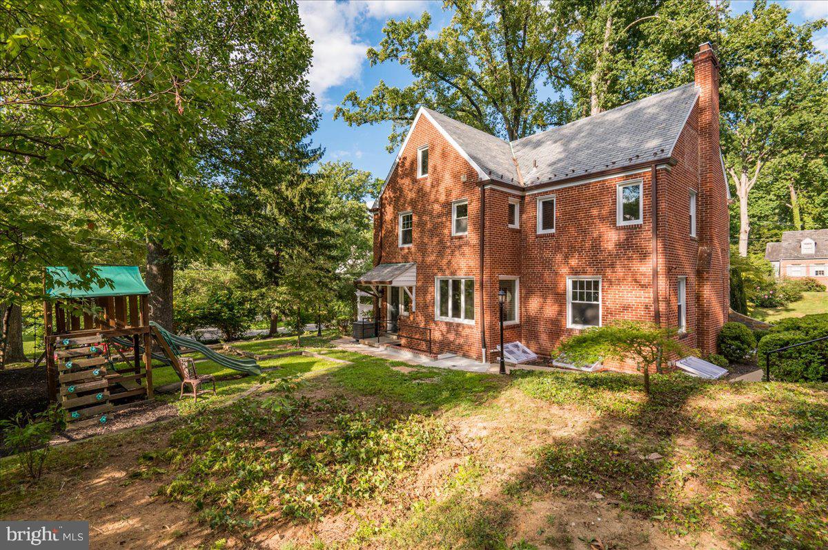 9214 Crosby Road Silver Spring, MD 20910 - Photo 55 of 65 a view of a white house with a yard and large trees