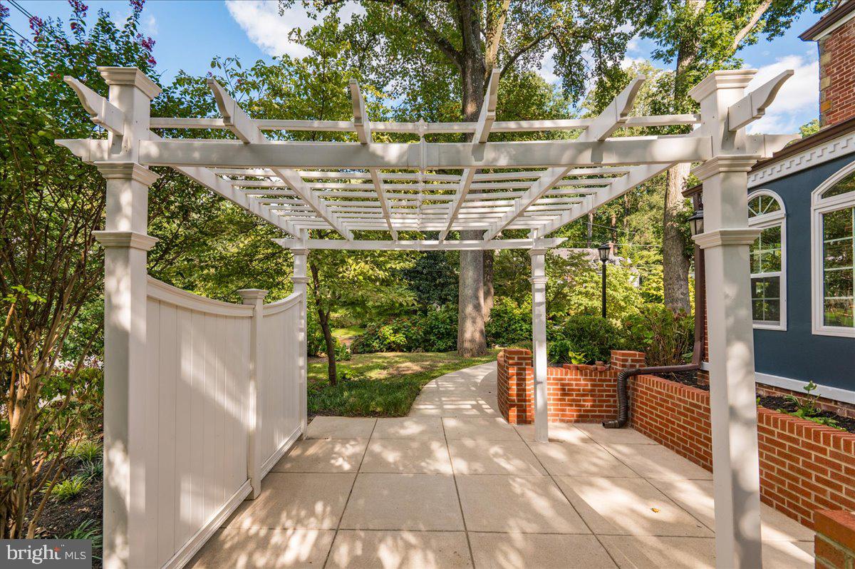 9214 Crosby Road Silver Spring, MD 20910 - Photo 59 of 65 a view of a patio with table and chairs potted plants with wooden floor and fence