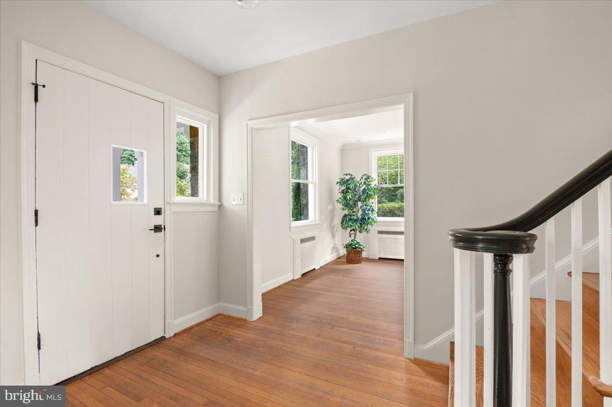 9214 Crosby Road Silver Spring, MD 20910 - Photo 10 of 65 a view of an empty room with wooden floor and a window