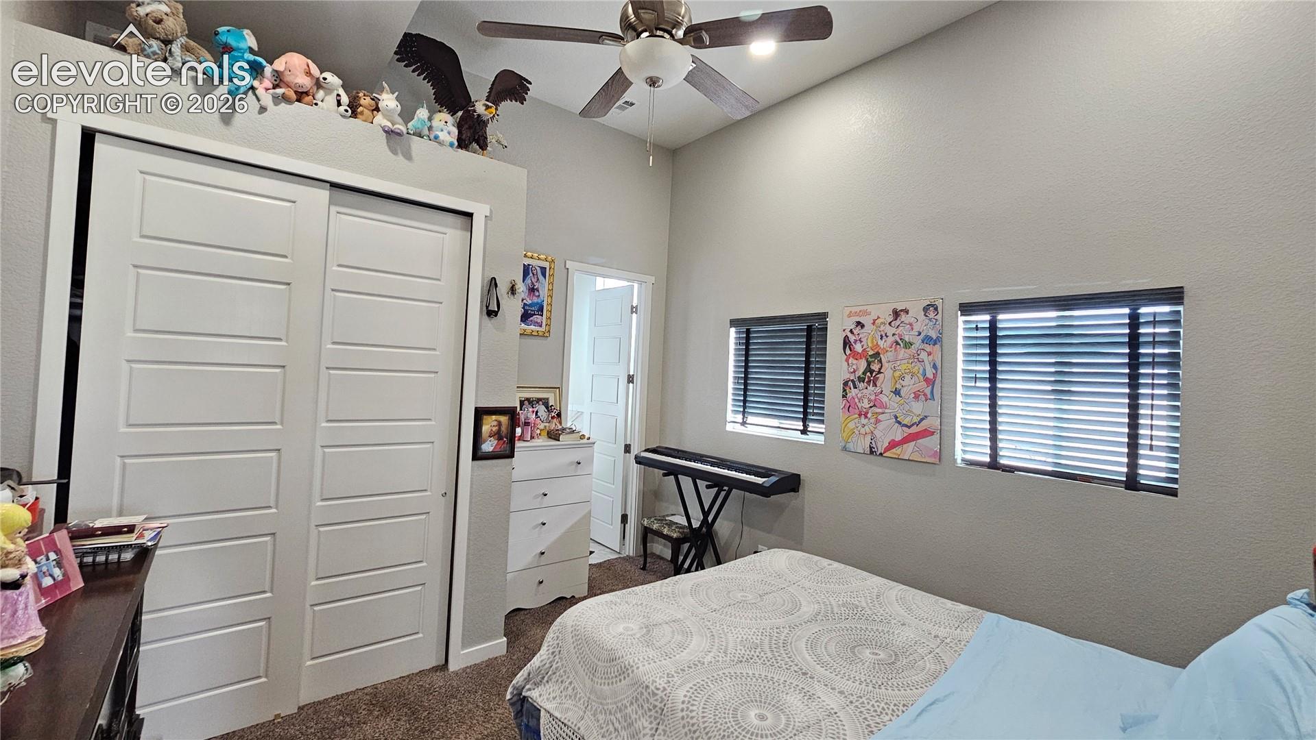 3835 Sengbeil Road Yoder, CO 80864 - Photo 22 of 48 Vaulted ceiling with a ceiling fan and recessed lighting, two windows with horizontal blinds, and a built-in closet with white panel doors