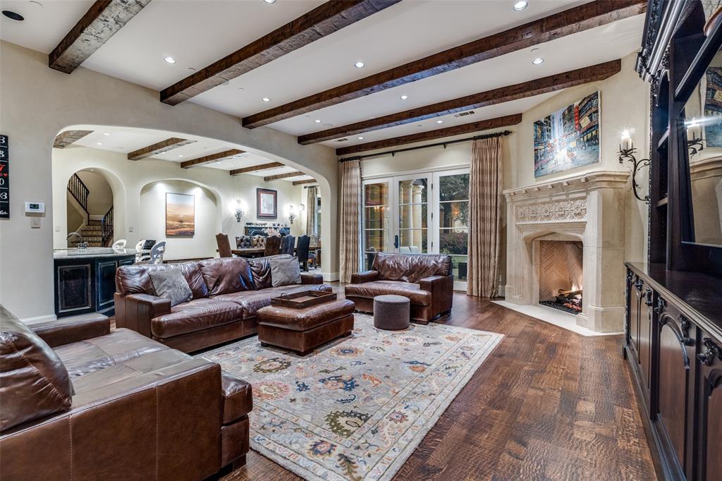 234 West Bethel Road Coppell, TX 75019 - Photo 13 of 40 a living room with furniture a fireplace and a flat screen tv