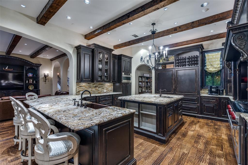234 West Bethel Road Coppell, TX 75019 - Photo 14 of 40 a kitchen with granite countertop a stove and a wooden floors