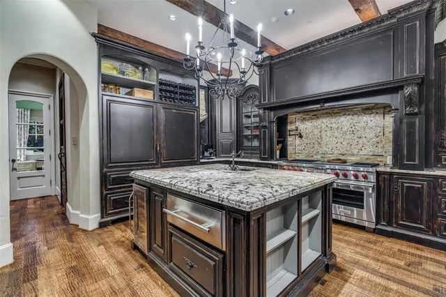a kitchen with a stove and a refrigerator