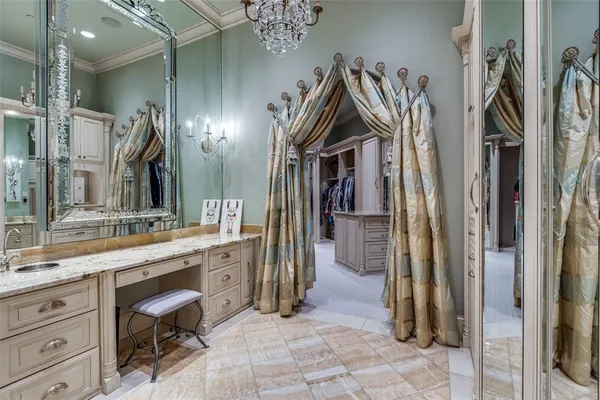 a view of a walk in closet and bathroom