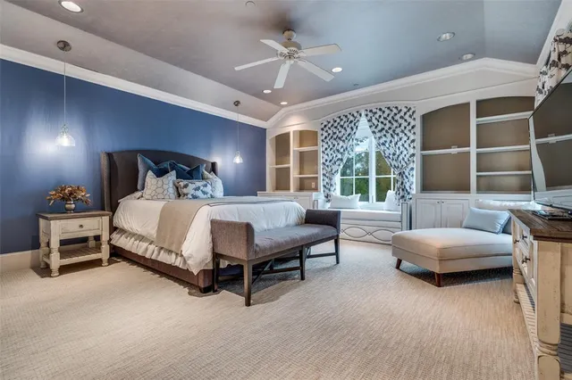 a bedroom with furniture and a large window